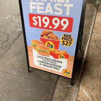 Chicken World - a family feast sign on a sidewalk - Chicken Shop Near Me - Vancouver, British Columbia