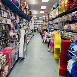 Party decorations aisle with piñatas.
