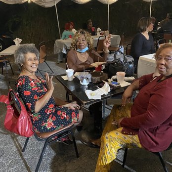 Nairobi Bar & Grill - a group of people sitting at a table - Bars Near Me - San Antonio, Texas