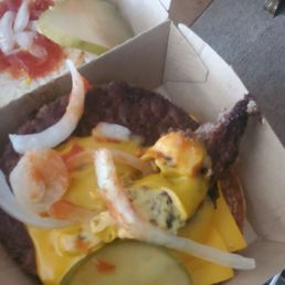 A discusting burger from McDonald's. They say wages aren't high enuf, but someone was definitely high when they made this.