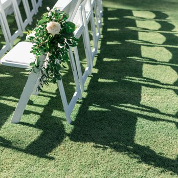 Thistle and Thorn Floral - Greenery and Floral arrangement on ceremony chairs - Floral Designers Near Me Thistle and Thorn Floral - Greenery and Floral arrangement on ceremony chairs - Floral Designers Near Me