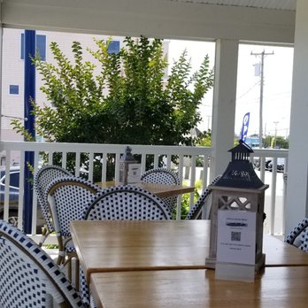 Surf City Bistro - a table and chairs on a porch - American Near Me - Surf City, New Jersey Surf City Bistro - a table and chairs on a porch - American Near Me - Surf City, New Jersey