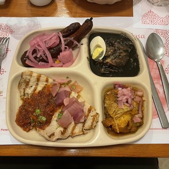Los Almendros - combo plate with longaniza, relleno negro, conchinita, and poc-chuc - Yucatan Near Me - Mérida, YUC Los Almendros - combo plate with longaniza, relleno negro, conchinita, and poc-chuc - Yucatan Near Me - Mérida, YUC