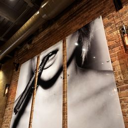 a pair of scissors hanging on a brick wall
