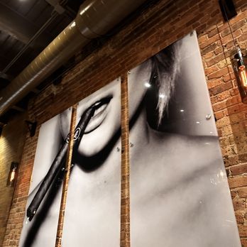 The Clayton - a pair of scissors hanging on a brick wall - Cigar Bars Near Me - Chicago, Illinois