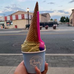 a hand holding an ice cream cone