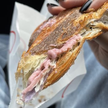 Bake Code Croissanterie - a person holding a sandwich - Bakeries Near Me - Toronto, Ontario