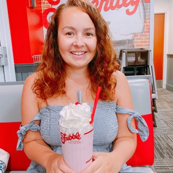 Friendly's - a woman sitting at a table with a milkshake - American Near Me - East Boston, Massachusetts Friendly's - a woman sitting at a table with a milkshake - American Near Me - East Boston, Massachusetts