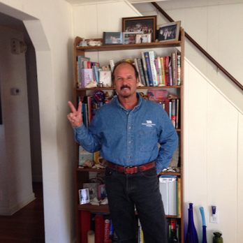 TJB Plumbing Heating - a man standing in front of a bookcase - Plumbing Near Me TJB Plumbing Heating - a man standing in front of a bookcase - Plumbing Near Me