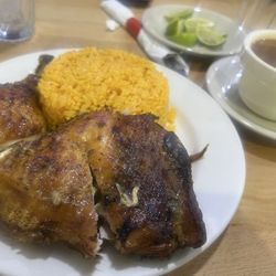 Caridad and Louie's Restaurant - Half a roasted chicken  yellow rice , beans near by. Yum.