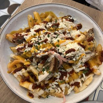 Rina - Street fries-- chicken shawarma, feta cheese, tahini, harissa, sumac pickled onion. - Middle Eastern Near Me - Atlanta, Georgia Rina - Street fries-- chicken shawarma, feta cheese, tahini, harissa, sumac pickled onion. - Middle Eastern Near Me - Atlanta, Georgia