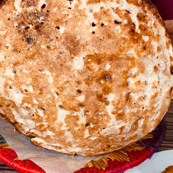 Lakshmi Chowk Kabob & Karahi - a person holding a flatbread - Halal Near Me - Ashburn, Virginia Lakshmi Chowk Kabob & Karahi - a person holding a flatbread - Halal Near Me - Ashburn, Virginia