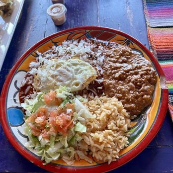 Fernando’s Tamales - Red Chile Enchiladas with rice and beans and fried egg on top. - Mexican Near Me - Carlsbad, New Mexico Fernando’s Tamales - Red Chile Enchiladas with rice and beans and fried egg on top. - Mexican Near Me - Carlsbad, New Mexico