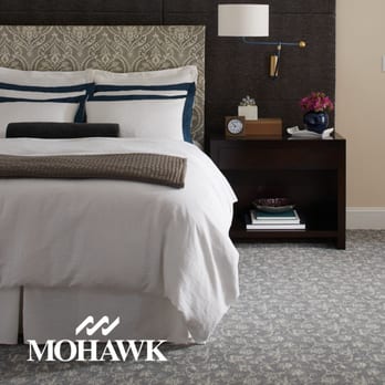 Floor Systems - a bedroom with a bed and nightstand - Carpet Installation Near Me - Huntingtown, Maryland