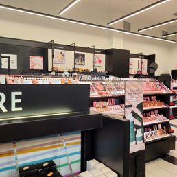 Grand Opening - Sephora store interior featuring makeup, fragrance, and skincare product displays with signage and promotional materials.