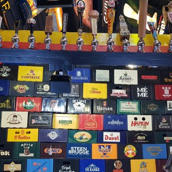 2be Beer Wall - Inside beer wall above the bar is decorations of beers, beer crates, old beer taps, kegs and posters - Bars Near Me - Bruges, VWV 2be Beer Wall - Inside beer wall above the bar is decorations of beers, beer crates, old beer taps, kegs and posters - Bars Near Me - Bruges, VWV
