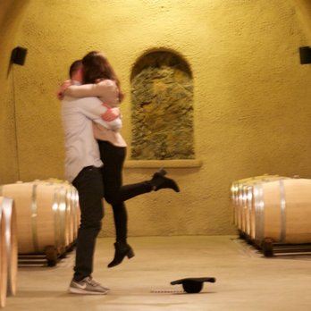 Jericho Canyon Vineyard - a man and a woman embracing in a wine cellar - Wineries Near Me - Calistoga, California Jericho Canyon Vineyard - a man and a woman embracing in a wine cellar - Wineries Near Me - Calistoga, California