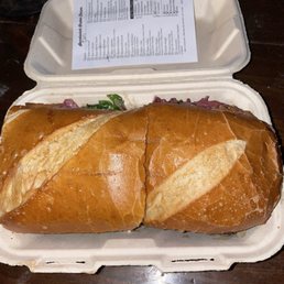 Pastrami and cheese sandwich with lots of toppings Pastrami and cheese sandwich with lots of toppings