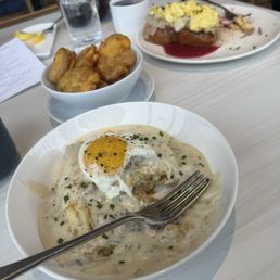 Biscuits and gravy, really gf pod potatoes and French toast topped with pork and an egg. Biscuits and gravy, really gf pod potatoes and French toast topped with pork and an egg.