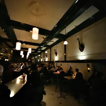 Bily Kun - people sitting at tables in a dimly lit restaurant - Bars Near Me - Montreal, Quebec