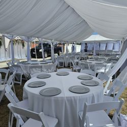 Laura's Table and Chair Rental - 20x50 drape tent with charger plates