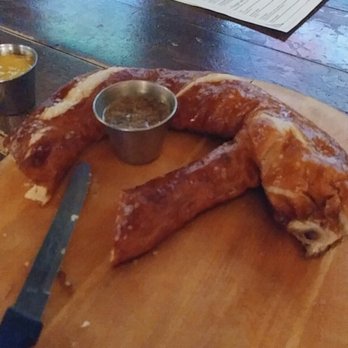 Prost! - Half pretzel, partly eaten...couldn't help myself. 2 mustard dipping sauces. I suggest adding the side of beer cheese. Amazing, regardless. - German Near Me - Chicago, Illinois