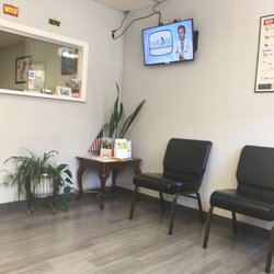 Ridge Road Animal Hospital - Clean and modern waiting room with flat screen TV showing interesting and informative program on various topics affecting pet ownership.