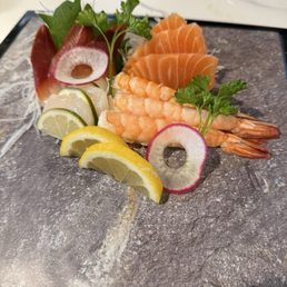 Scallop, soft clam, tiger shrimp, and salmon sashimi Scallop, soft clam, tiger shrimp, and salmon sashimi
