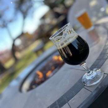 The Good Lot - a glass of beer on a table - Beer Gardens Near Me - Cedar Park, Texas The Good Lot - a glass of beer on a table - Beer Gardens Near Me - Cedar Park, Texas