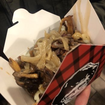 Smoke's Poutinerie - a person holding a box of food - Poutineries Near Me - Saskatoon, Saskatchewan Smoke's Poutinerie - a person holding a box of food - Poutineries Near Me - Saskatoon, Saskatchewan