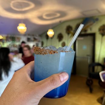 Kitty Cohen's - a hand holding a blue drink - Venues & Event Spaces Near Me - Austin, Texas Kitty Cohen's - a hand holding a blue drink - Venues & Event Spaces Near Me - Austin, Texas