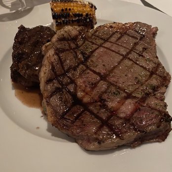Bluewater Grill - Rib-eye with baked garlic, signature steak and creamy smoked corn. - Steakhouses Near Me - Cancún, ROO Bluewater Grill - Rib-eye with baked garlic, signature steak and creamy smoked corn. - Steakhouses Near Me - Cancún, ROO