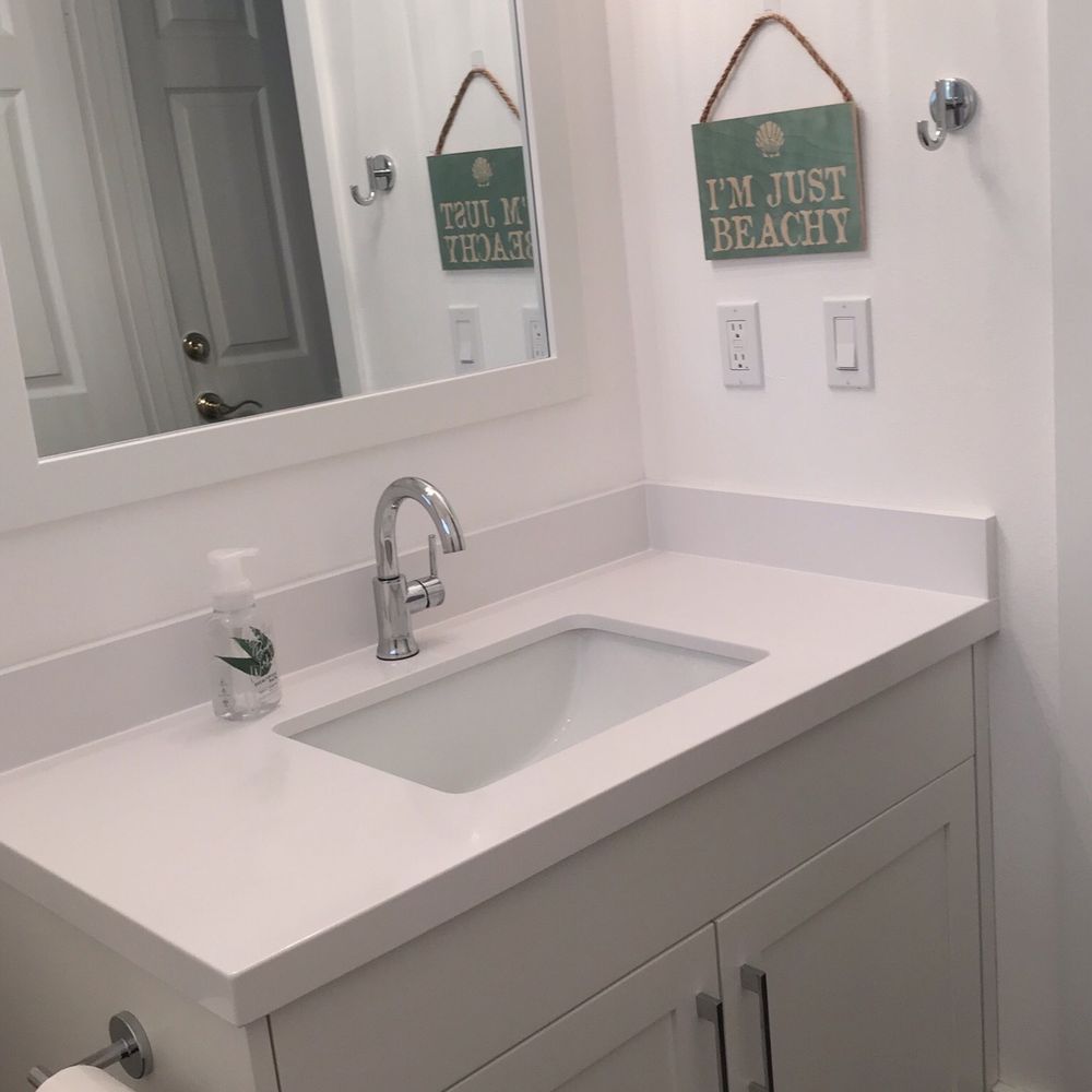 Versatile Construction - a bathroom with a sink and mirror - General Contractors Near Me Versatile Construction - a bathroom with a sink and mirror - General Contractors Near Me