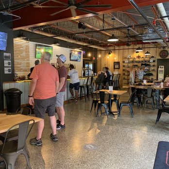 Hatchet Brewing - a group of people sitting at tables - Breweries Near Me - Southern Pines, North Carolina