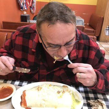 Azteca Mexican Restaurant - My hubby pigging out on his huge Smothered Burrito   which he did not finish!!  These babies were only $9!! - Mexican Near Me - Willmar, Minnesota