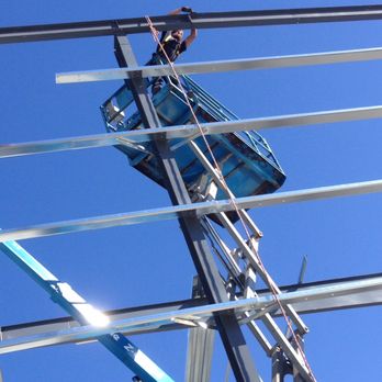 Quality Builders - a man on a lift working on a metal structure - Roofing Near Me - Paducah, Kentucky Quality Builders - a man on a lift working on a metal structure - Roofing Near Me - Paducah, Kentucky