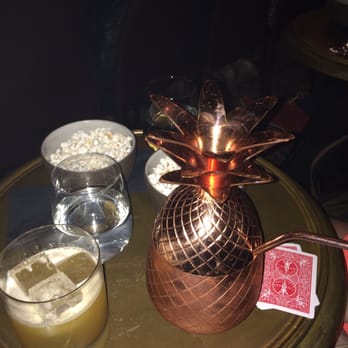 The Magician - THE pineapple drink plus rye whiskey drink and the chicken truffle popcorn in the back! - Magicians Near Me - New York, New York The Magician - THE pineapple drink plus rye whiskey drink and the chicken truffle popcorn in the back! - Magicians Near Me - New York, New York
