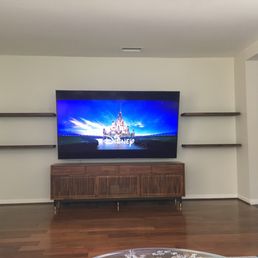 Floating shelves installed around our 85" TV. Look great! Floating shelves installed around our 85" TV. Look great!