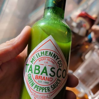 Spurs Cafe - a hand holding a bottle of tabasco - American Near Me - Wickenburg, Arizona