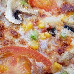 Campino Pizza - Veggie pizza in Kristiansand Norway. All the usual veggies plus pineapple and corn kernels. Kind of busy tasting but very good.