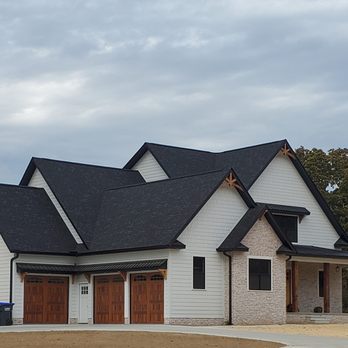 Dream Builders - Bloomington - a white house with a black roof - General Contractors Near Me - Bloomington, Indiana Dream Builders - Bloomington - a white house with a black roof - General Contractors Near Me - Bloomington, Indiana