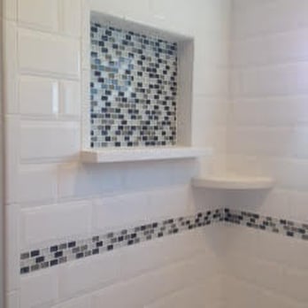 Two Guys Home Improvements - The decorative insert and border adds a detailed touch to this subway tile bath area. - General Contractors Near Me Two Guys Home Improvements - The decorative insert and border adds a detailed touch to this subway tile bath area. - General Contractors Near Me