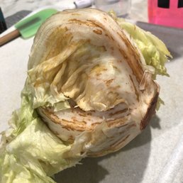 a head of lettuce on a cutting board