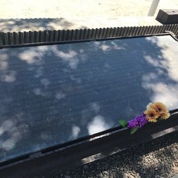 One of the two plaques at the site. The flowers are a nice touch. One of the two plaques at the site. The flowers are a nice touch.
