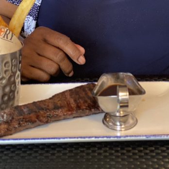 Victory Meat and Seafood - a woman sitting at a table with a steak and french fries - Seafood Near Me - Elmhurst, Illinois Victory Meat and Seafood - a woman sitting at a table with a steak and french fries - Seafood Near Me - Elmhurst, Illinois