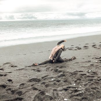Katie McSweeney Yoga - Classic splits with an added backbend has many benefits. (The beach is more freezing than it looks in Iceland!) - Yoga Near Me Katie McSweeney Yoga - Classic splits with an added backbend has many benefits. (The beach is more freezing than it looks in Iceland!) - Yoga Near Me