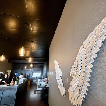Meet Crab - a large white angel wing on the wall of a restaurant - Seafood Near Me - Albuquerque, New Mexico