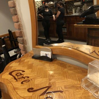 Cafe Napoli - a wooden table with a glass of wine on it - Italian Near Me - Manchester, New Jersey