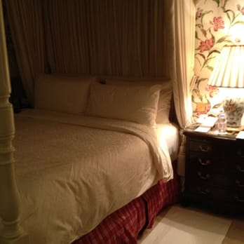Four Seasons Hôtel George V - Classy turndown. Slippers on floor. Evian on nightstand. - Hotels Near Me - Paris, 75 Four Seasons Hôtel George V - Classy turndown. Slippers on floor. Evian on nightstand. - Hotels Near Me - Paris, 75