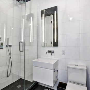 Lithos Marble Works - a bathroom with a toilet, sink, and shower - Flooring Near Me - Astoria, New York